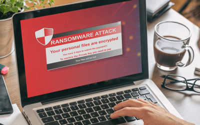 Person On Laptop With Ransomware Attack Notice